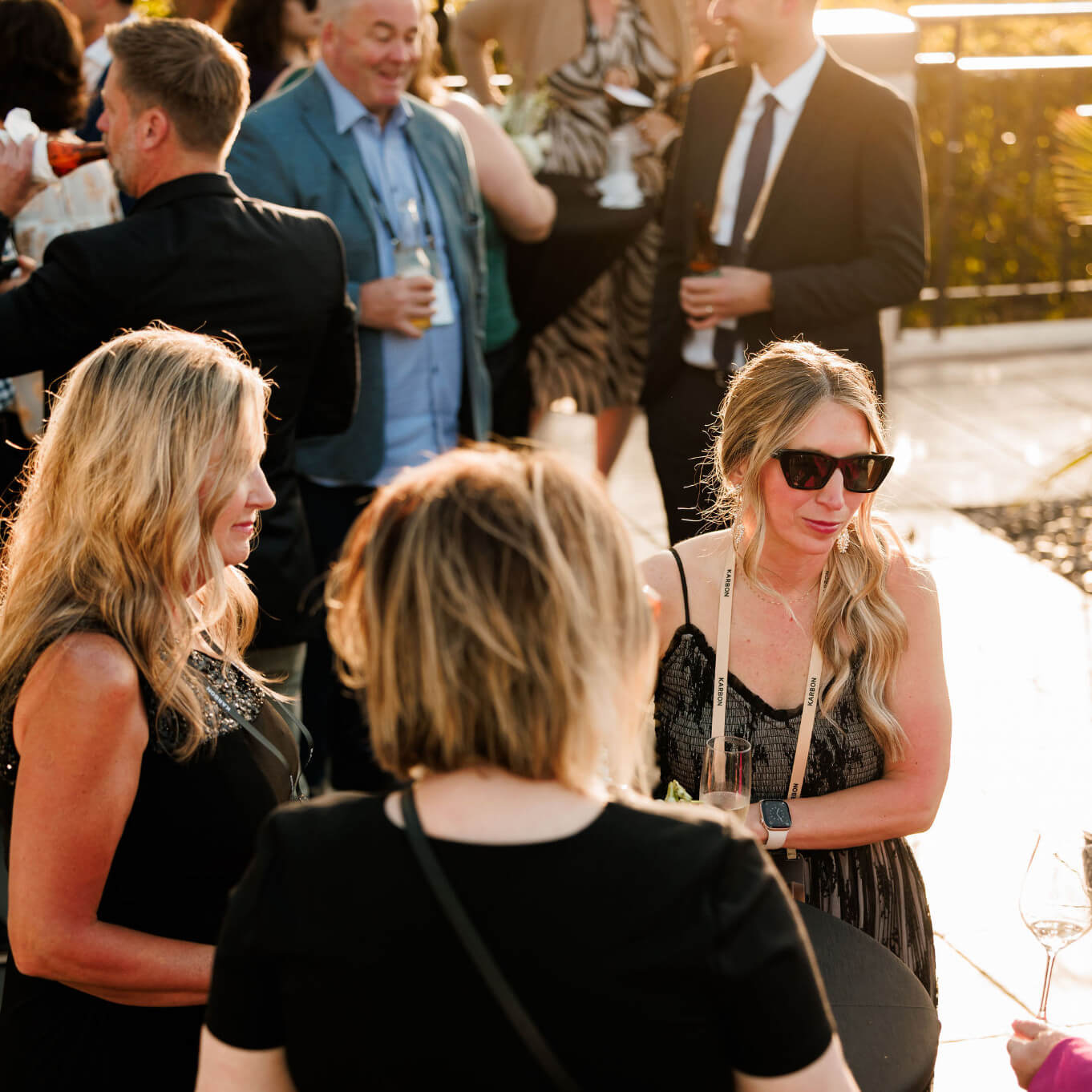 A group of Karbon Next attendees talking at an outdoor evening networking reception