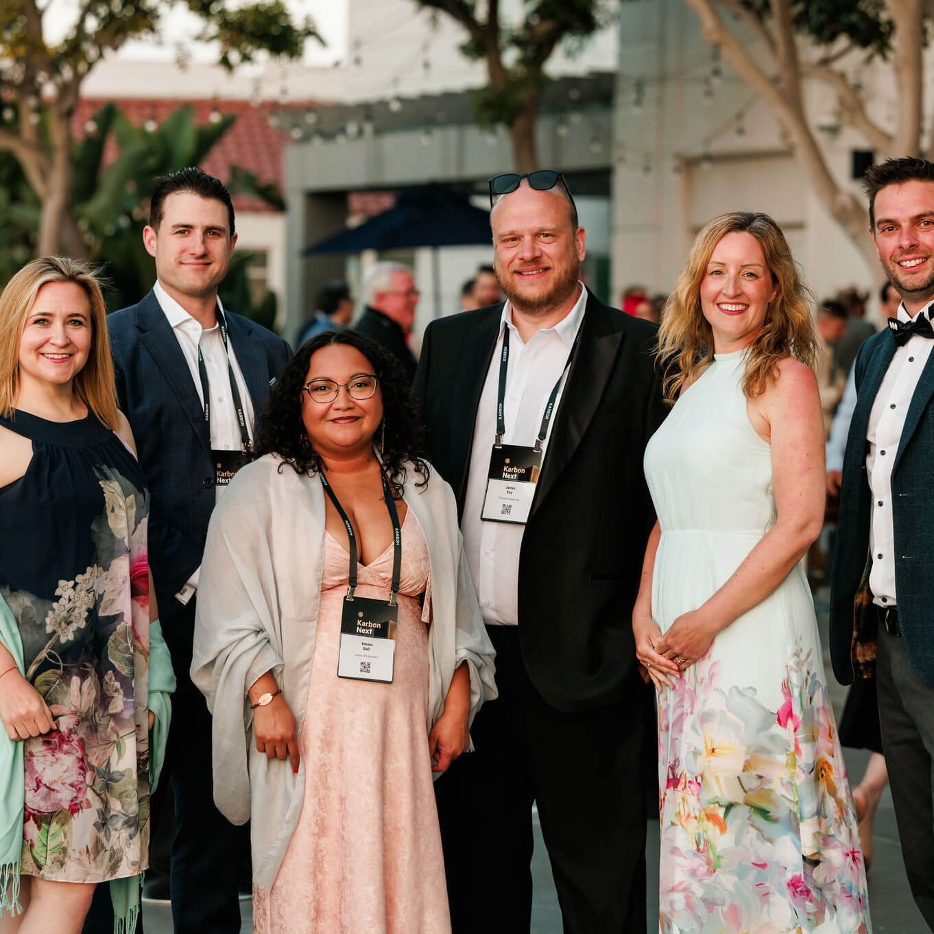 Six Karbon Next attendees in formal attire posing together at the gala dinner