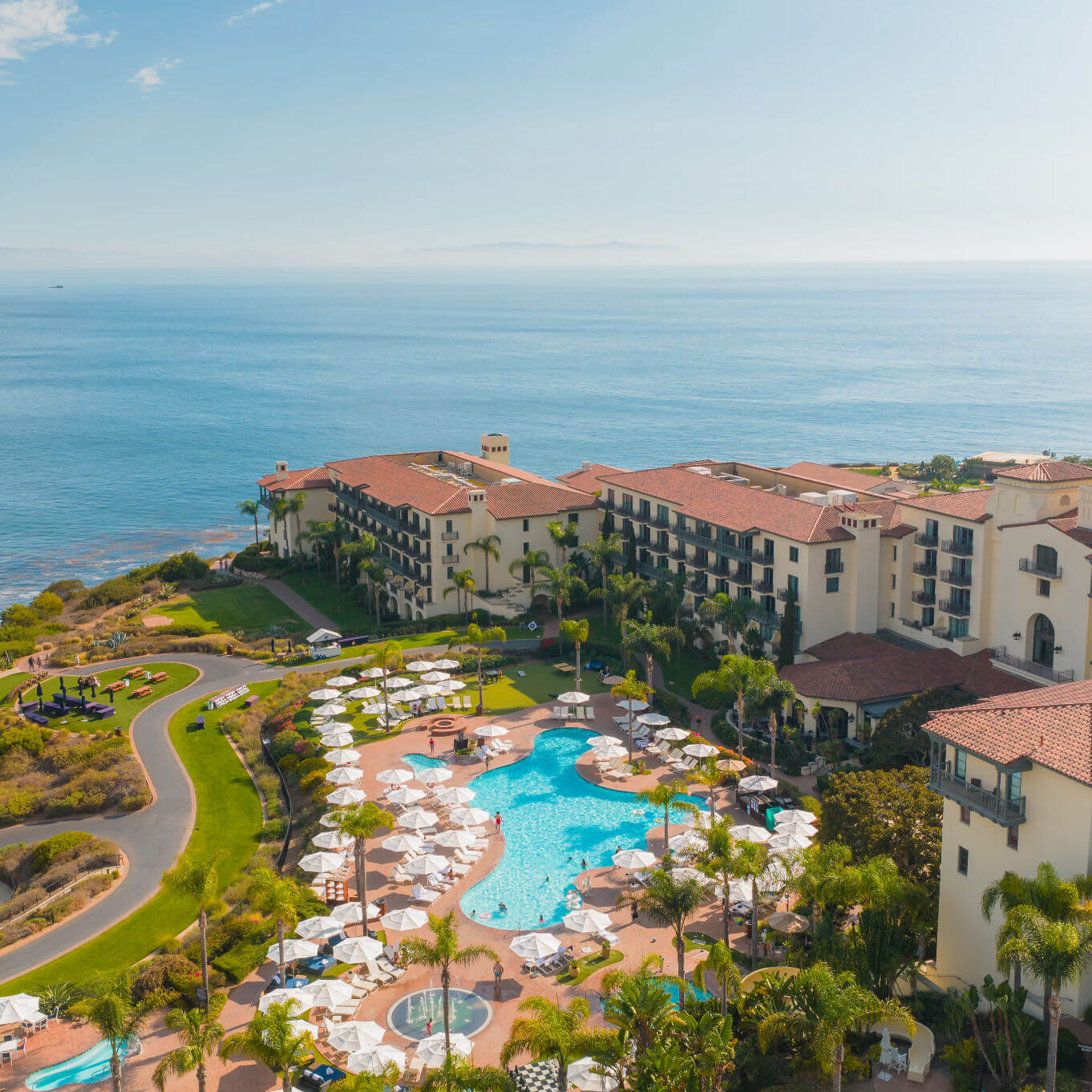 Aerial view of Terranea Resort showing the pool area, hotel buildings, and the Pacific Ocean
